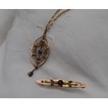 An Edwardian 9ct yellow gold pendant set with a sapphire and seed pearls on a 9ct yellow gold chain