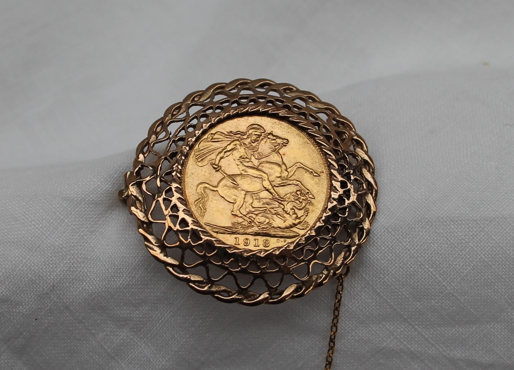 A George V gold sovereign dated 1913, in a yellow metal pierced frame mount, unmarked, - Image 2 of 3