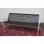 A cast iron and wooden slatted bench, the pierced sides cast with stylised dragons,