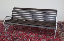 A cast iron and wooden slatted bench, the pierced sides cast with stylised dragons,