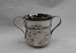 A George III silver two handled cup, with floral embossing,