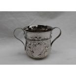 A George III silver two handled cup, with floral embossing,