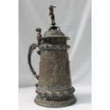 A WMF electroplated lidded stein, with a cherub in a helmet holding a flaming torch terminal,