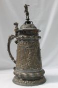 A WMF electroplated lidded stein, with a cherub in a helmet holding a flaming torch terminal,