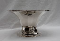 A late George VI silver bowl of flared panelled form on a leaf raised base and stepped circular