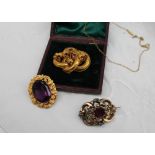A Victorian brooch, set with a central faceted amethyst in a yellow metal mount,