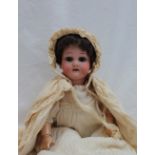 A Heubach Koppelsdorf bisque head doll, with closing brown eyes, open mouth and teeth,