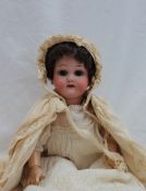 A Heubach Koppelsdorf bisque head doll, with closing brown eyes, open mouth and teeth,