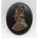A bronze wall plaque depicting Horatio Nelson in profile, mounted on an ebonised board,