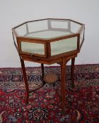 A late Victorian rosewood bijouterie table of octagonal form inlaid with husk chains on slender