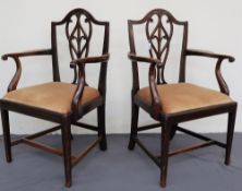 A pair of George III mahogany elbow chairs with arched back and interlaced splat, scrolled arms,