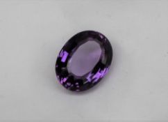 An unmounted amethyst, of oval faceted form, measuring approximately 22mm x 16mm, approximately 4.
