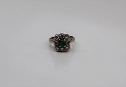 An emerald and diamond ring, the central emerald 50 x 55mm,