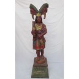 A carved wood model of a cigar store Red Indian, with a feathered headdress,