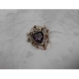 An amethyst and seed pearl brooch of shield shape,