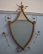 A gilt decorated shield shaped wall mirror with shell decoration,