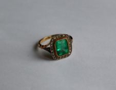 An emerald and diamond ring, the step cut emerald approximately 9mm x 8mm,