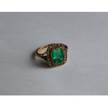 An emerald and diamond ring, the step cut emerald approximately 9mm x 8mm,