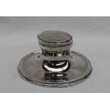 A George V silver desk inkwell of plain round capstan shape, makers Hutton & Sons,