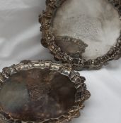 A pair of George II silver waiters, with a shell and scroll border,