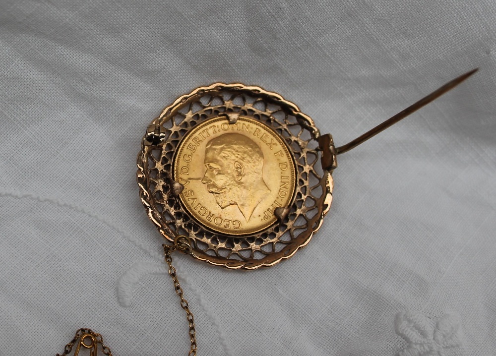 A George V gold sovereign dated 1913, in a yellow metal pierced frame mount, unmarked, - Image 3 of 3