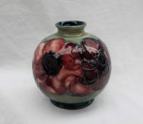 A Moorcroft pottery vase, of globular form decorated in the anemone pattern to a green ground,