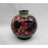 A Moorcroft pottery vase, of globular form decorated in the anemone pattern to a green ground,