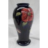 A large Moorcroft pottery Clematis pattern vase to a Royal blue ground, of inverted baluster form,