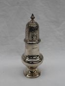 A George V silver sugar caster, with a turned finial above a baluster body and spreading foot,