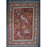 A Kashmir crewel work rug, the central red ground with huntsmen on horseback,