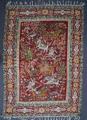 A Kashmir crewel work rug, the central red ground with huntsmen on horseback,