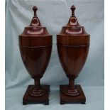 A pair of George III mahogany knife boxes of urn shape, the stepped covers with acorn finials,