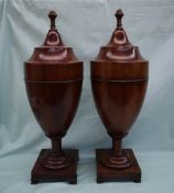 A pair of George III mahogany knife boxes of urn shape, the stepped covers with acorn finials,