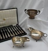 A George V silver sauce boat, with a flared rim, leaf scrolling handle on three paw feet, Chester,