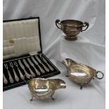 A George V silver sauce boat, with a flared rim, leaf scrolling handle on three paw feet, Chester,