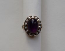 A 9ct yellow gold dress ring, with a cabochon amethyst surrounded by pearls, size P,