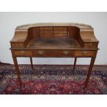 An Edwardian mahogany Carlton house type desk in the Georgian taste decorated with satinwood cross