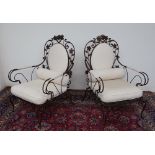 A pair of wrought iron elbow chairs, of wirework form,