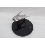 A chrome car mascot / hood ornament, possibly from a Buick,