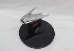 A chrome car mascot / hood ornament, possibly from a Buick,