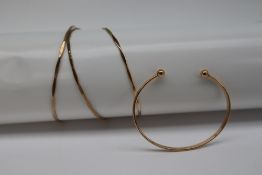 A 9ct gold slave bracelet together with three other 9ct gold bangles,