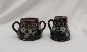 A Doulton Lambeth stoneware cream jug and twin handled sugar basin,