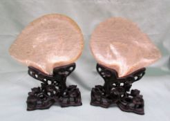 A pair of Chinese carved mother of pearl shells, finely relief decorated with pagodas,