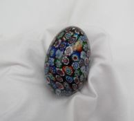 A glass paperweight of egg shape, decorated with multiple canes,