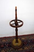 A mahogany and brass umbrella stand,