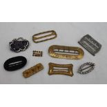 A collection of shoe buckles, various sizes,