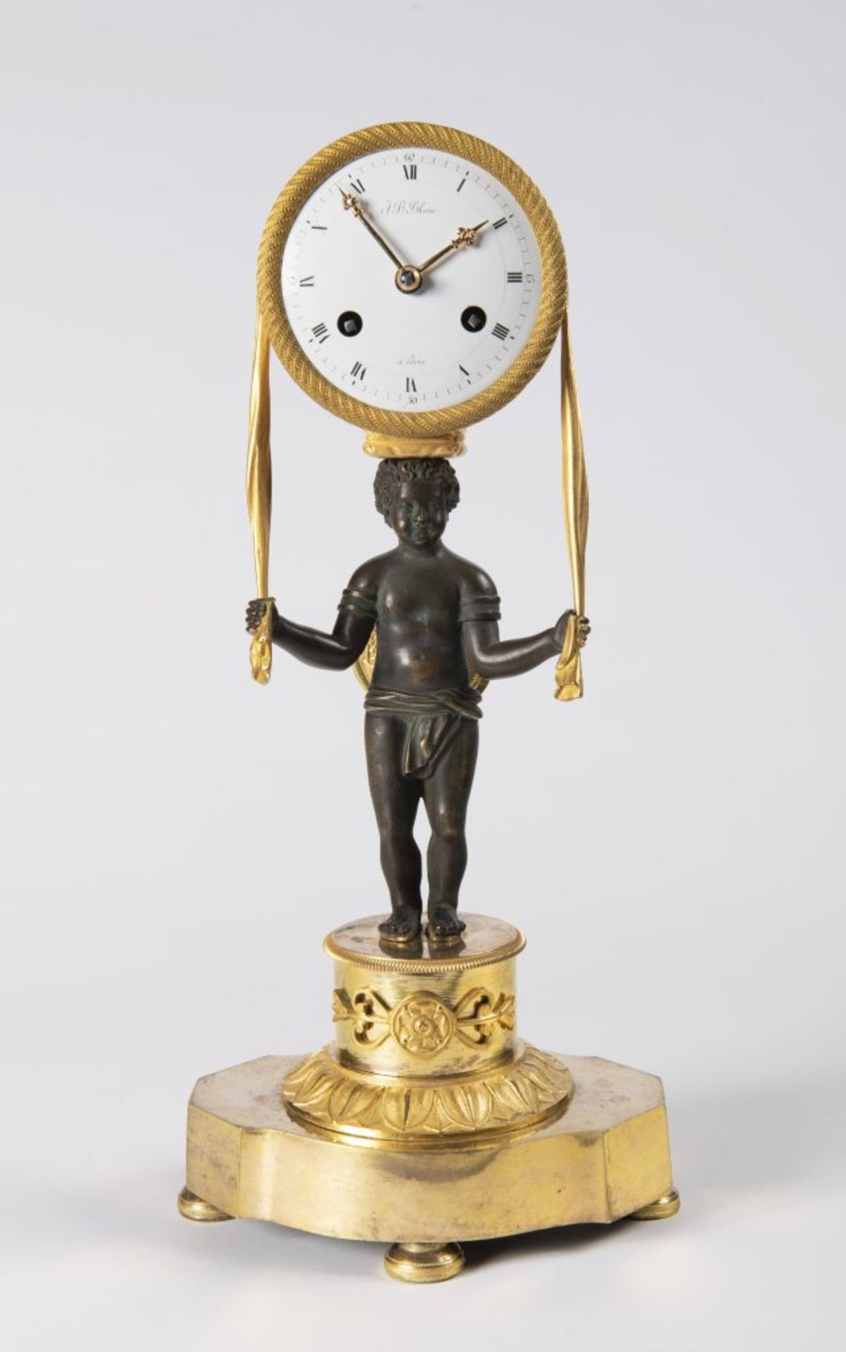 AN EMPIRE TABLE CLOCK Ca. 1810 France Paøíž Gilt bronze, enamel 37 x 17 x 10 cm This elegant,