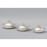 A GRADUATED SET OF THREE SWISS SILVERPLATE SERVING DISHES, BY ORFEVRERIE H. BEARD MONTREAUX,