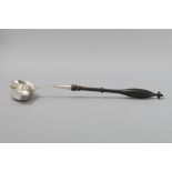 A CONTINENTAL SILVER TODDY LADLE, with ivory finial, ebonized fruitwood handle, 43cm (length).