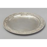 A CONTINENTAL SILVER CIRCULAR TRAY, with gadrooned rim, border embossed with shells, flowers and